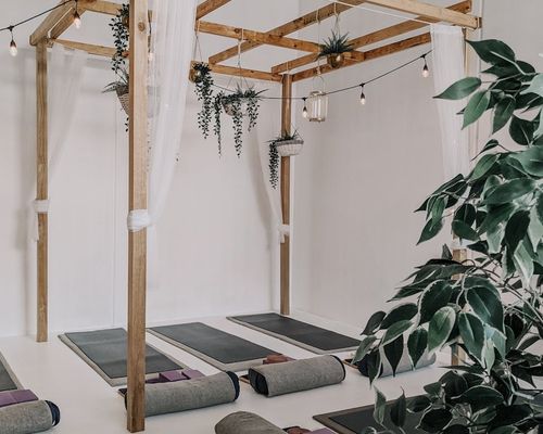 Minimalist yoga studio interior with soft natural lighting.